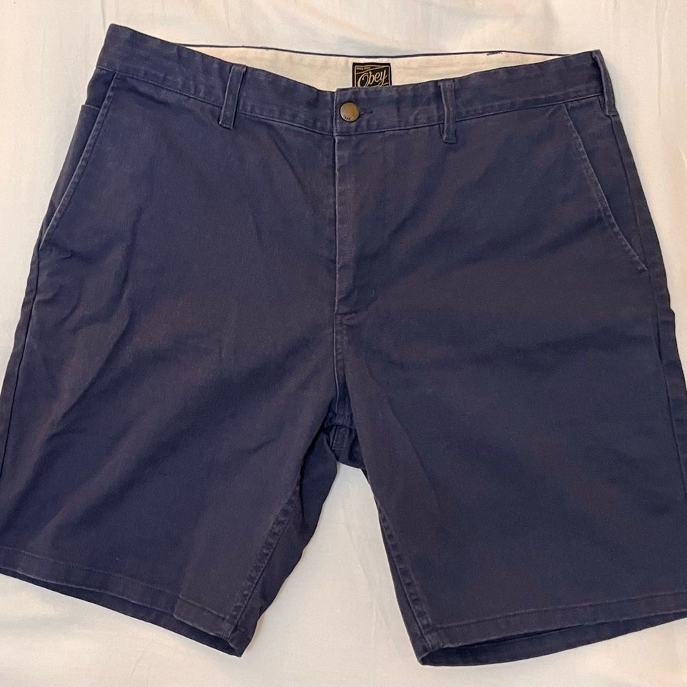 Size 34 waist Men’s Obey Propaganda flat front 9” inseam navy blue shorts.